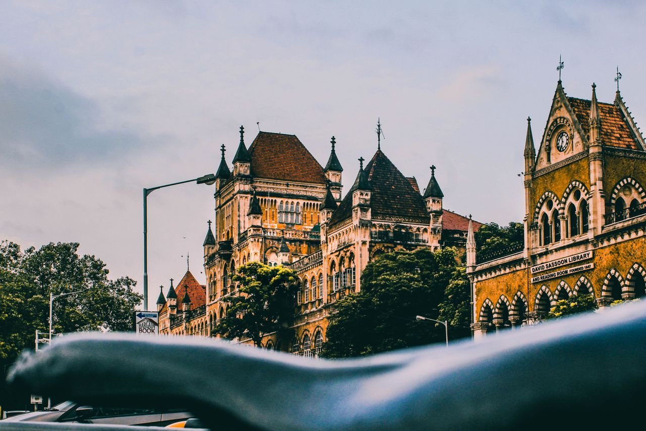 Historic David Sassoon Library in Mumbai showcasing Gothic architectural style in a vibrant city setting.