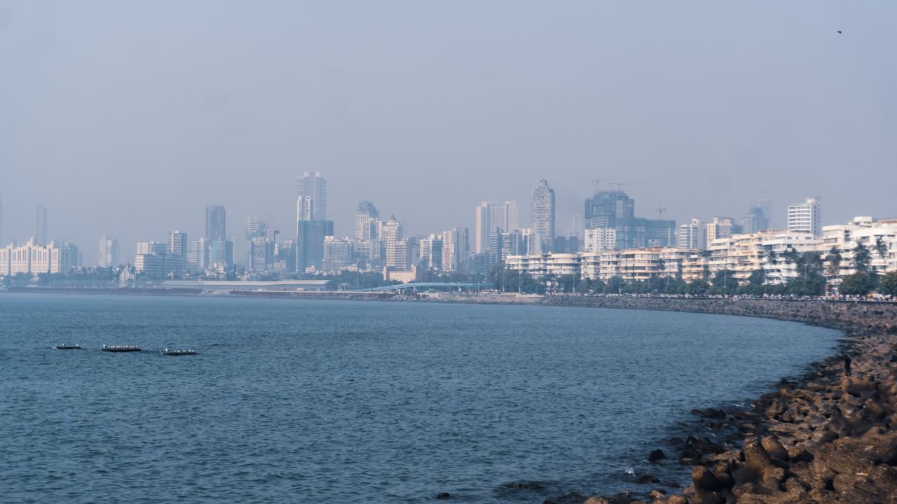 Captivating view of Marine Drive with Mumbai skyline and Arabian Sea under a clear sky.