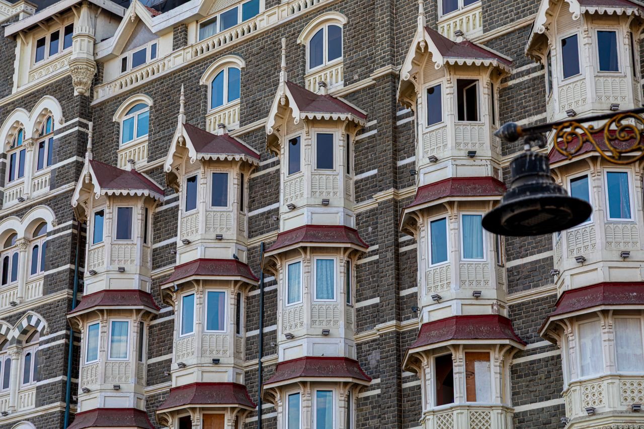 Detailed view of the historic Taj Mahal Palace facade in Mumbai, showcasing its Victorian architecture.